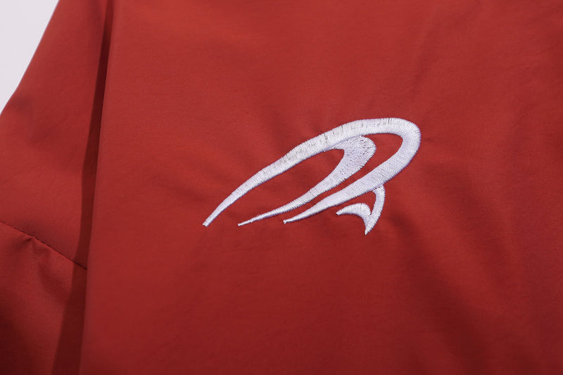 Close-up of red sweatshirt chest logo embroidery on smooth fabric