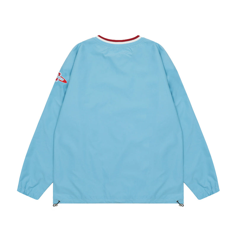 Back view of light blue oversized windbreaker with red and white ribbed neck trim