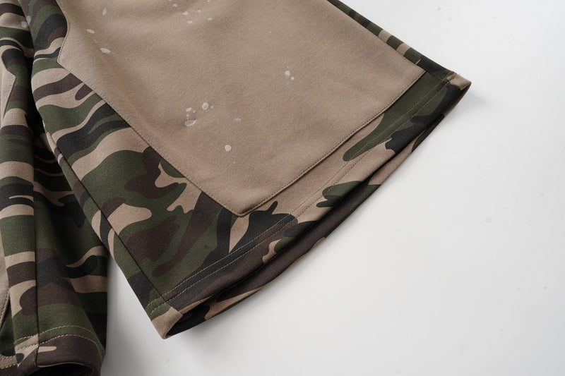 Close-up of tan leg panel and hem on camo patchwork baggy shorts