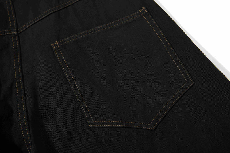 Close-up of black back pocket with stitched pentagon-shaped pocket detail