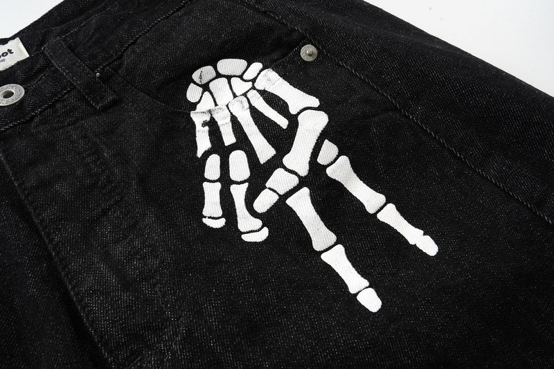 Close-up of black denim front graphic with white skeleton hand print