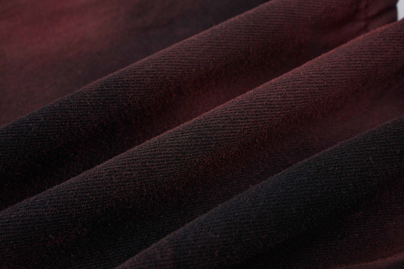 Close-up of burgundy and black denim fabric with soft woven texture and dark wash