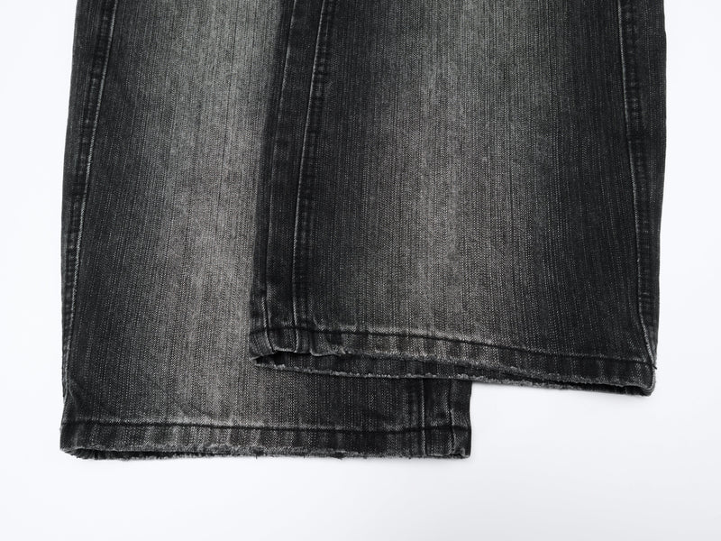 Lower legs and hems of black wide-leg denim pants with faded wash