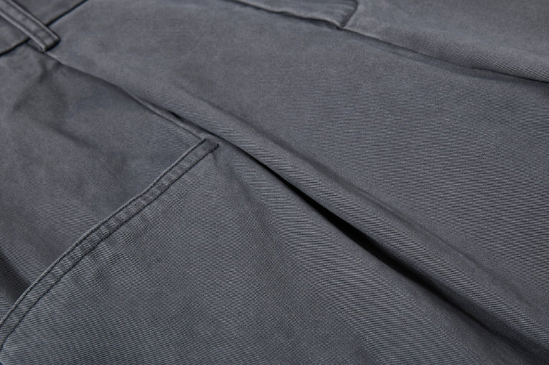 Close-up of dark gray front pocket and pleat detail
