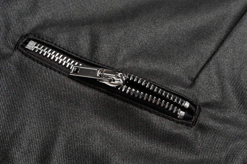 Close-up of a front zip pocket on black leather-effect pants