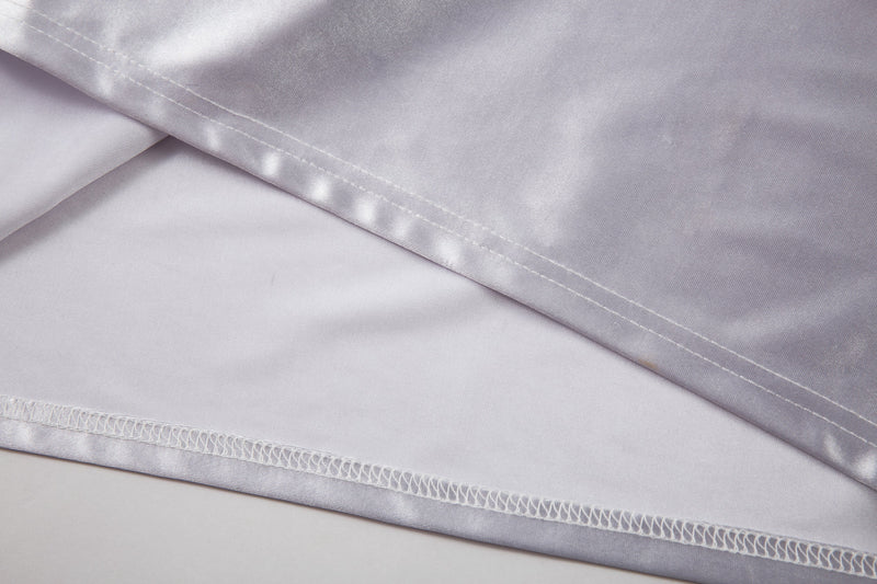 Close-up of white jersey hem seam and stitched cuff edge
