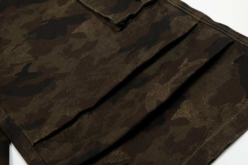 Close-up of wide camo shorts leg with front pleats and seam stitching