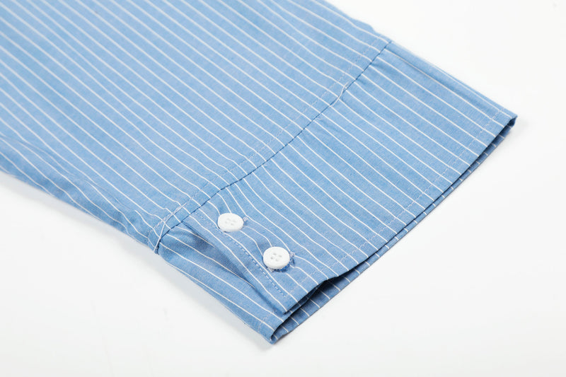 Close-up of blue striped shirt sleeve cuff with two white buttons
