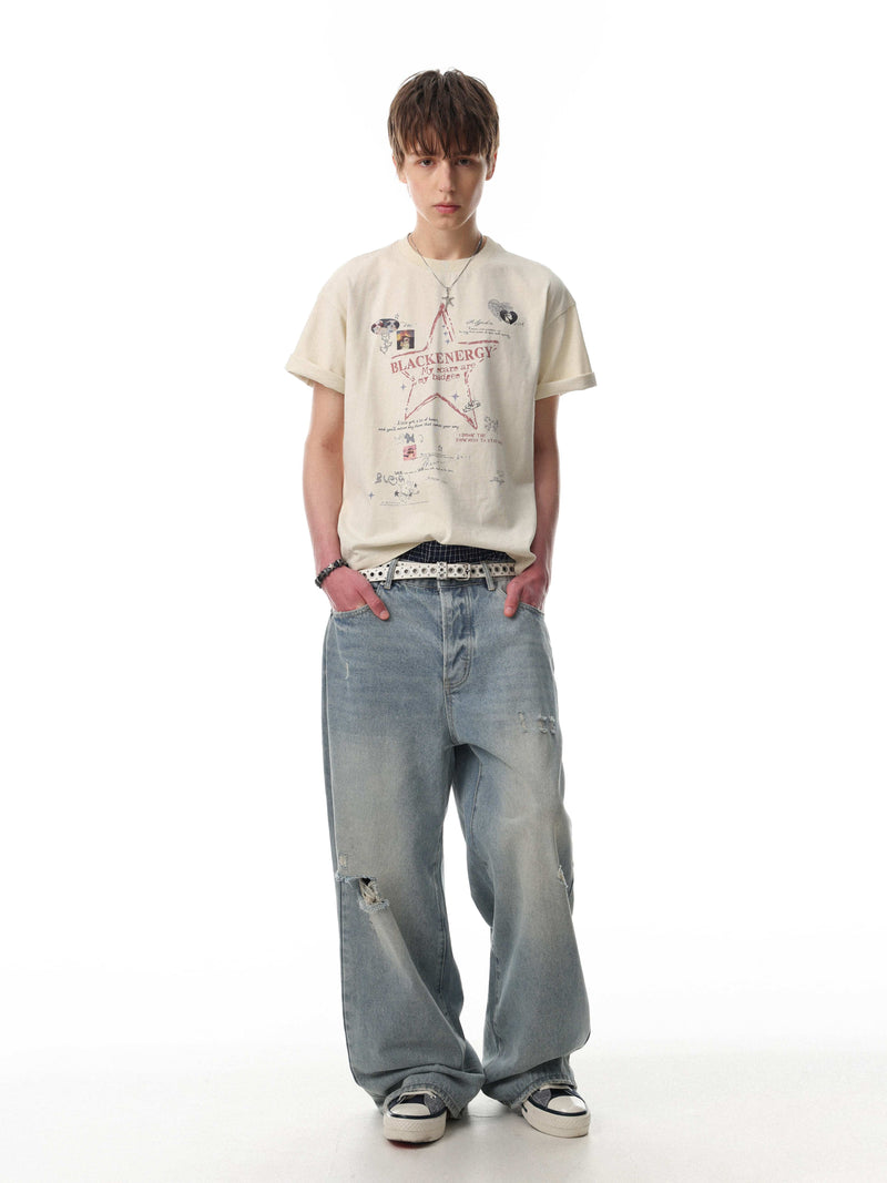 Oversized cream cotton graphic tee with Blackenergy star print, worn with baggy distressed jeans on a model