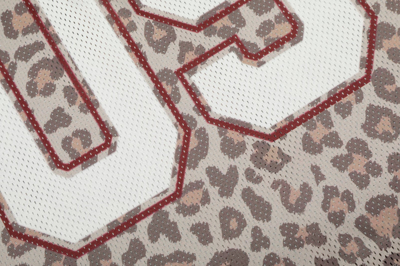 Leopard print mesh varsity jersey with red number outline and white sportswear fabric