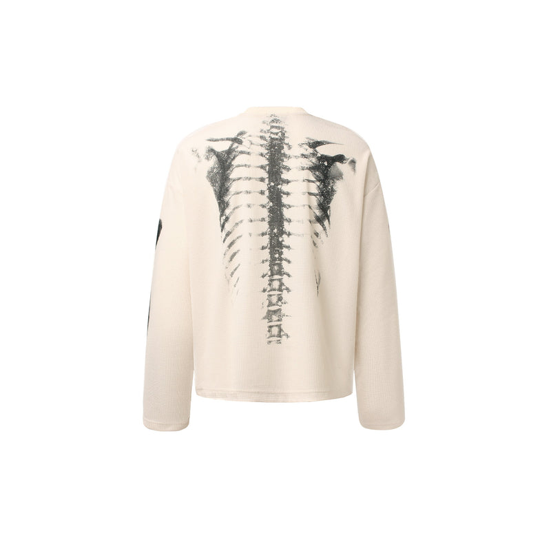 Cream waffle-knit long sleeve tee with black skeleton x-ray print on the back