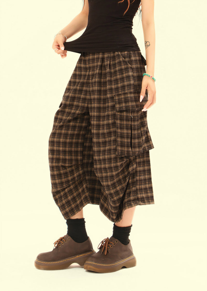 Side view of plaid cargo shorts showing draped wide leg and cargo pocket detail