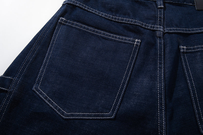 Close-up of one back pocket on deep-indigo wide-leg jeans