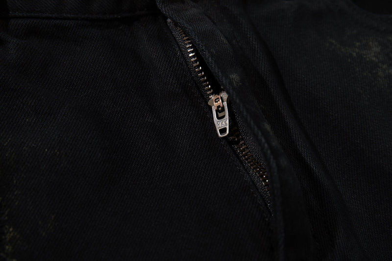 Close-up of metal zipper on black denim jeans