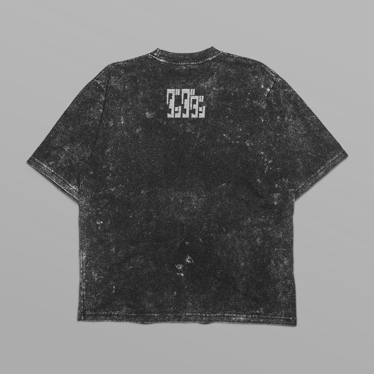 The Dandadan Monochrome Oversized T-Shirt features a black distressed texture, with an Okarun graphic front and logo on the upper back. White rectangular markings enhance its anime streetwear style and edgy vibe.