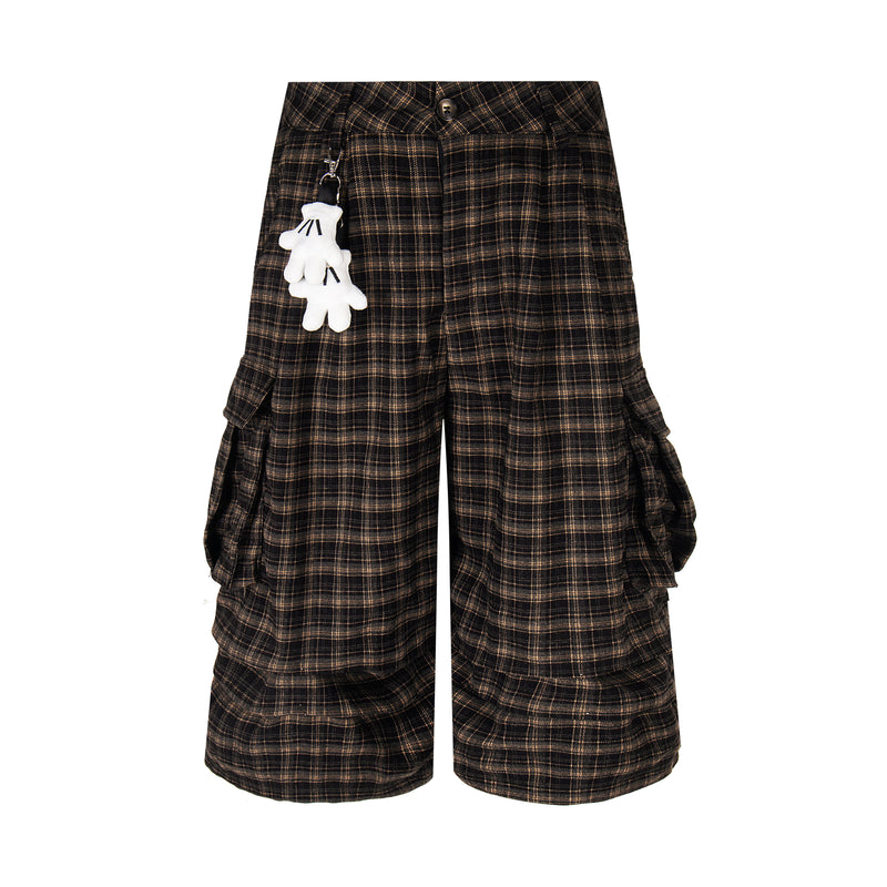 Front view of black and brown plaid cargo shorts with hanging white keychain
