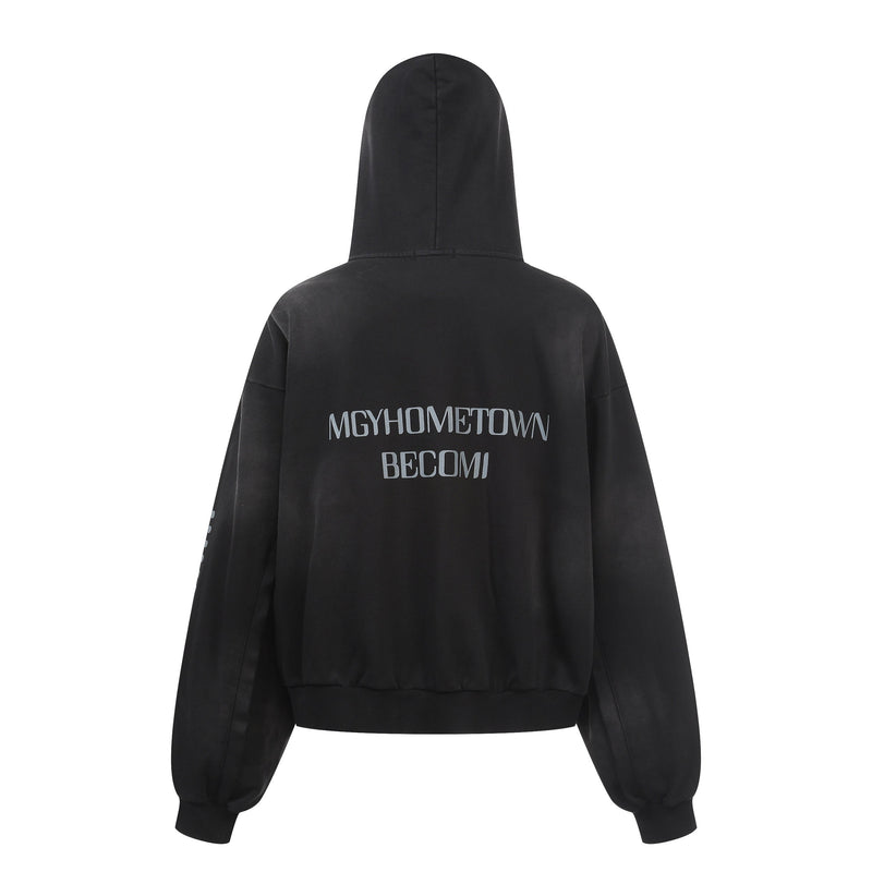 Back view of black distressed zip hoodie with gray text graphic and solid hood