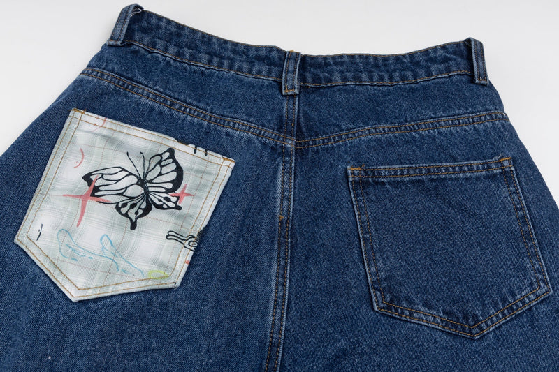 Back waist of blue wide-leg jeans with butterfly print patch pocket and plain pocket