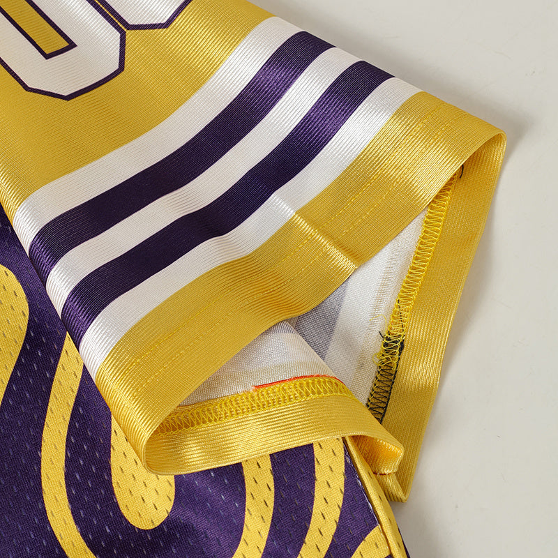 Close-up of a purple and gold varsity football jersey sleeve with striped trim and stitched details