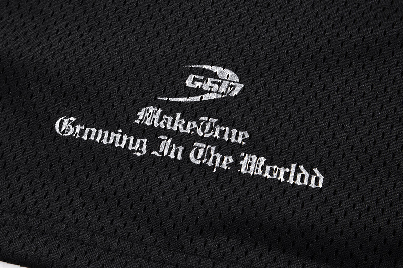 Close-up of black mesh fabric with white Gothic Make One Growing In The World print