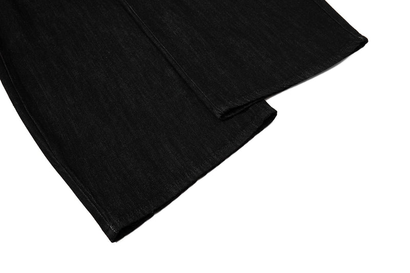 Close-up of lower leg hem on black denim pants