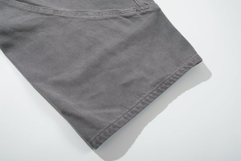 Close-up of gray jeans wide leg hem with straight stitched cuff