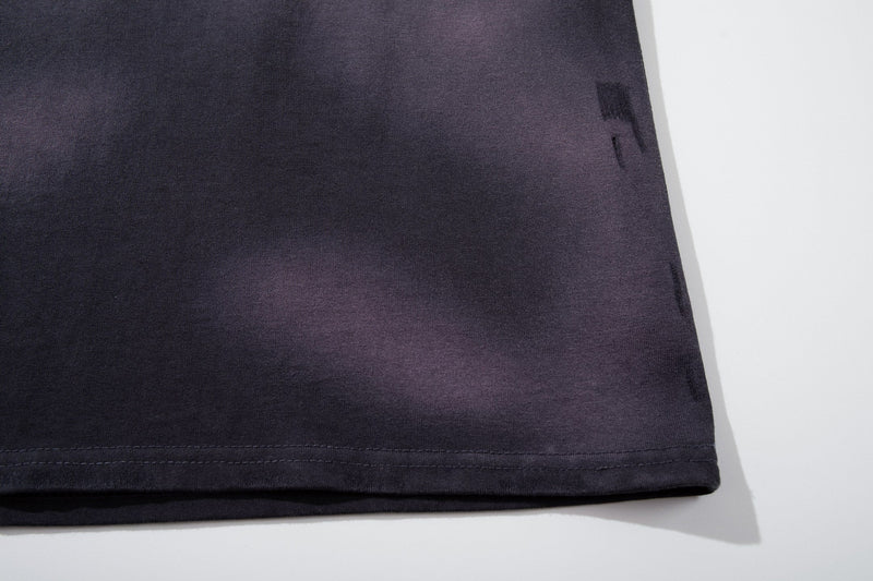 Washed black vintage raglan band tee hem with grunge fade on soft graphic shirt fabric