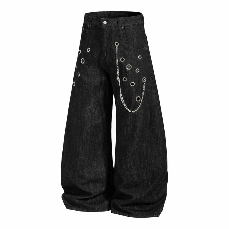 Wide-leg black denim pants with eyelets and chain, angled front view