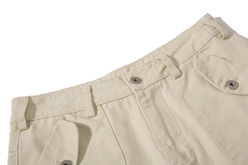 Close-up of beige cargo pant waistband with belt loops and snap button