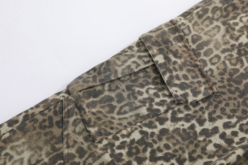 Close-up of side cargo pocket on leopard print shorts with flap detail and seam stitching