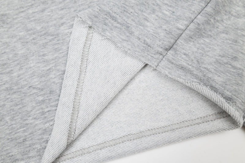 Close-up of inside hem and sleeve seam on heather gray long sleeve tee