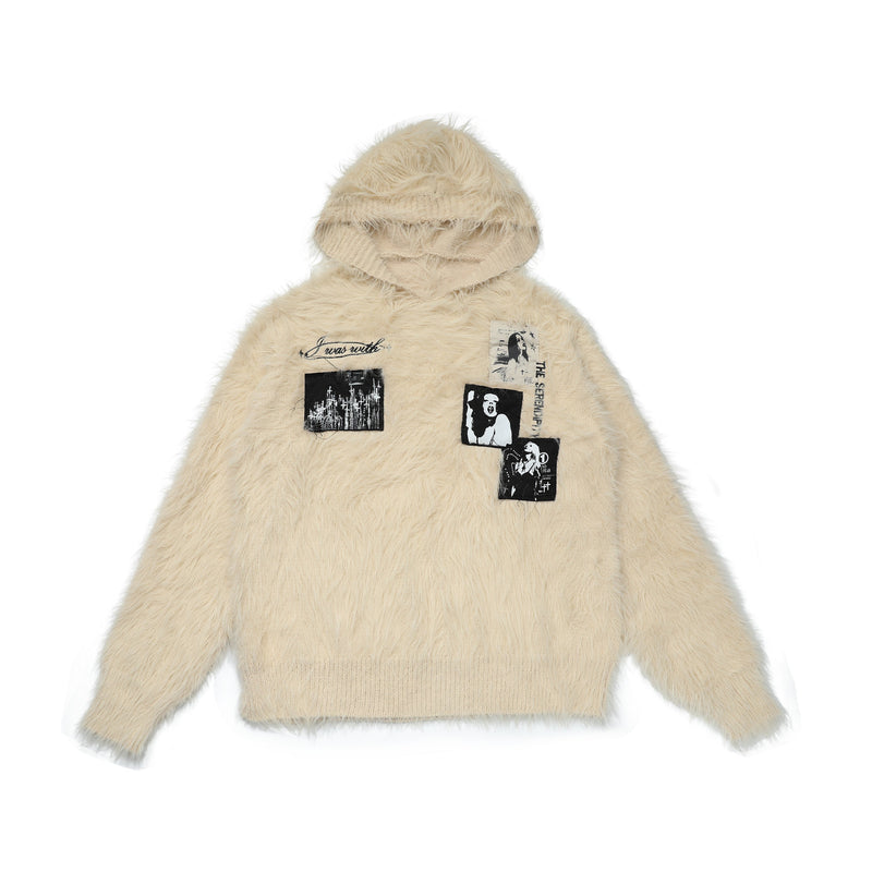 Cream fuzzy knit hoodie sweater with black graphic patches, front view