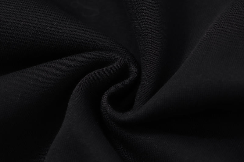 Close-up of black hoodie fabric texture with soft gathered folds