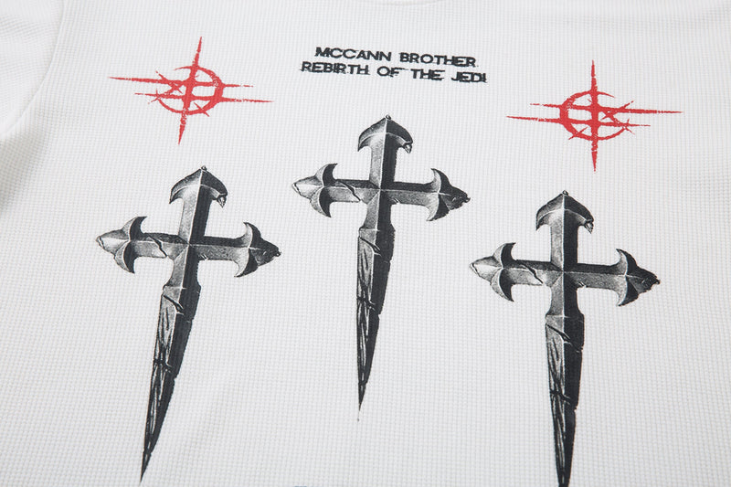 Front graphic on white long sleeve tee with three black crosses and red symbol accents