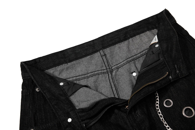 Inside waistband view of black denim pants with chain and pocket lining