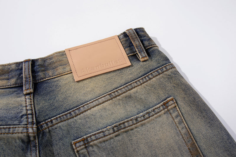 Back waistband close-up showing leather label and belt loops on washed denim