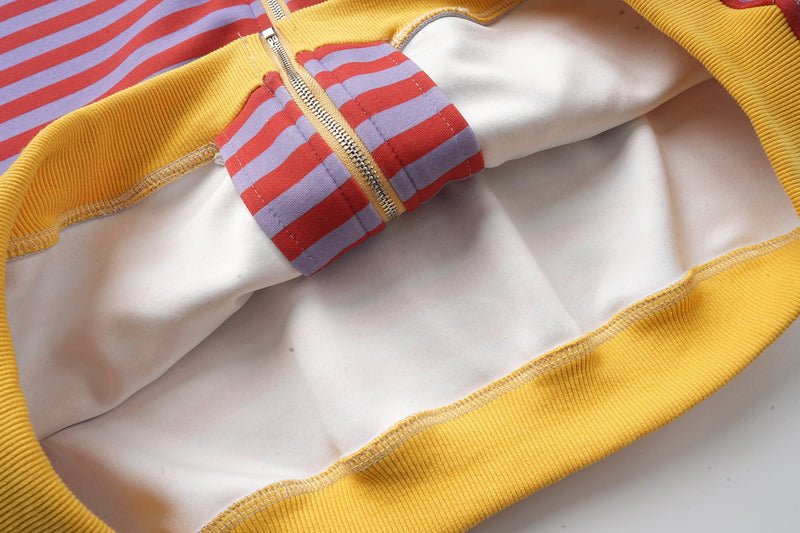 Inside view of zip-up hoodie with white lining and yellow ribbed trim