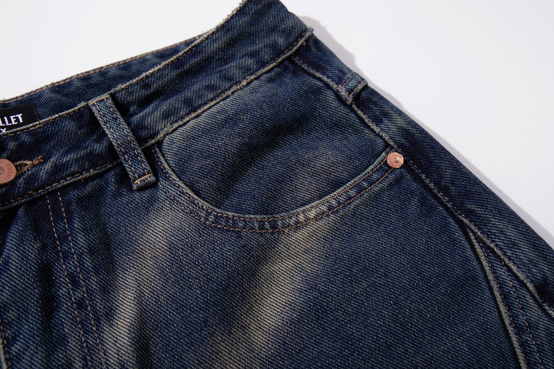 Close-up of front pocket and waistband on smoke-fade vintage blue denim jeans