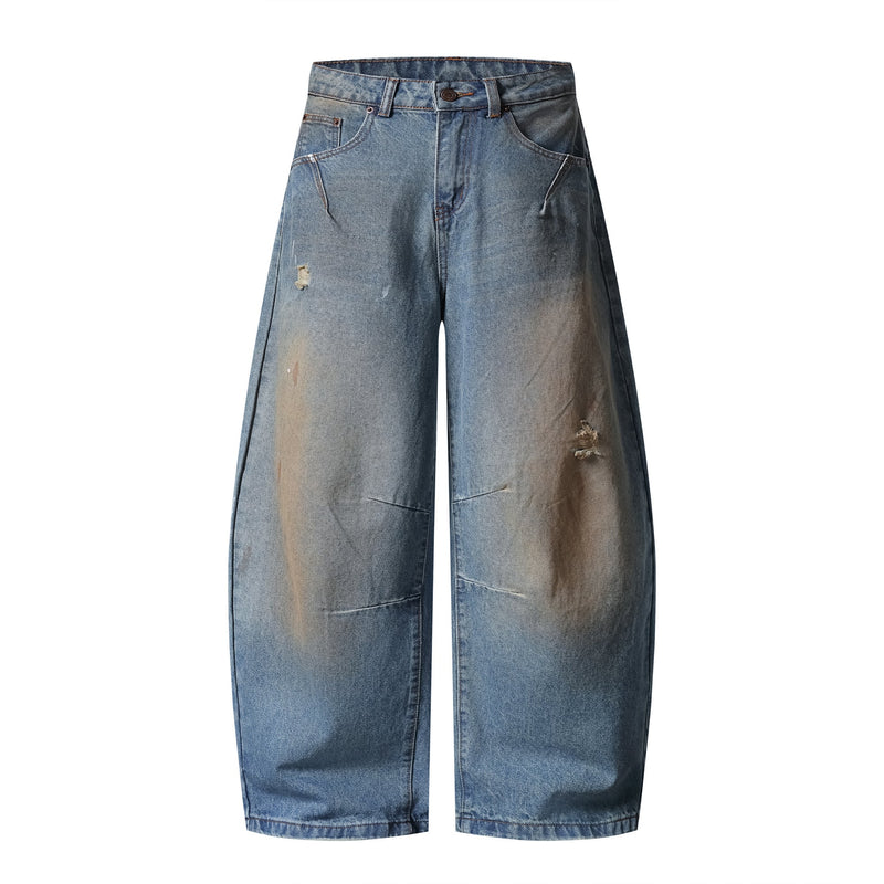 Front view of light blue wide-leg jeans with distressed wash and ripped details