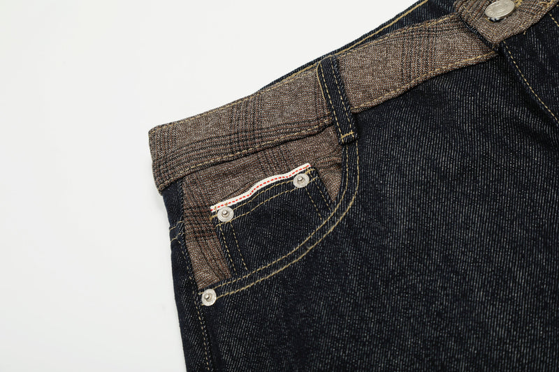 Close-up of front pocket and contrast waistband on dark wash jeans