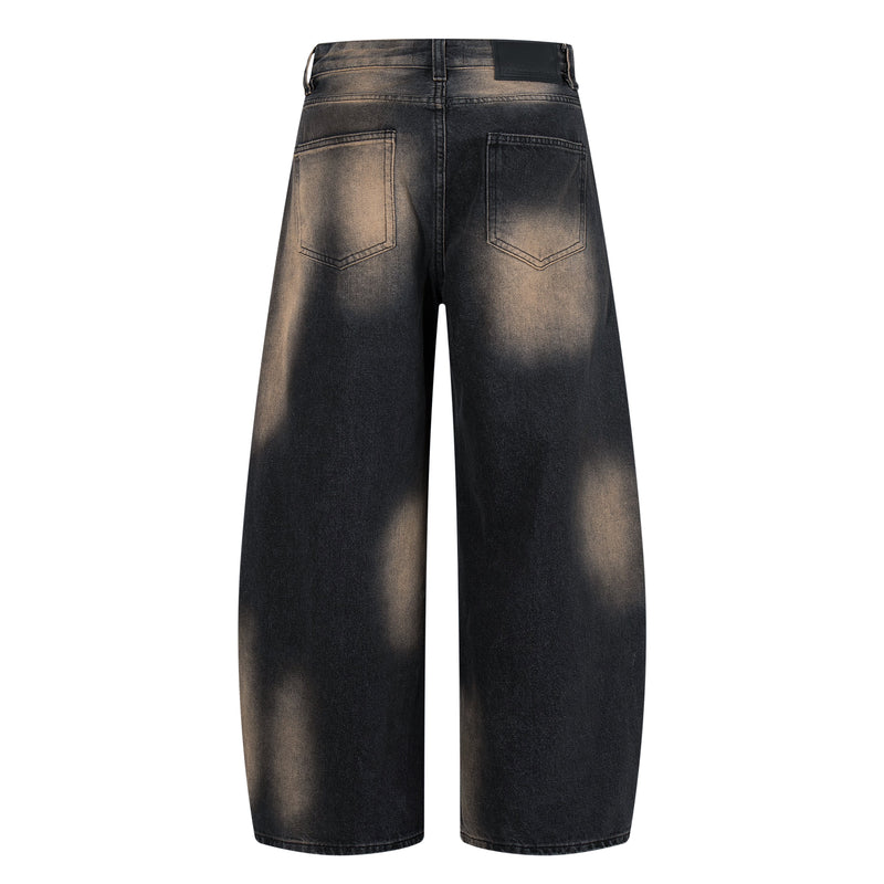 Back view of black fade wide-leg jeans with patch pockets and leather brand patch at waist