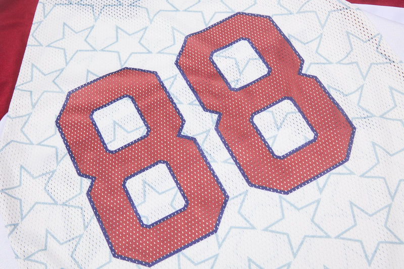 Close-up of white mesh football jersey with red number 88 and light blue star pattern on varsity streetwear top