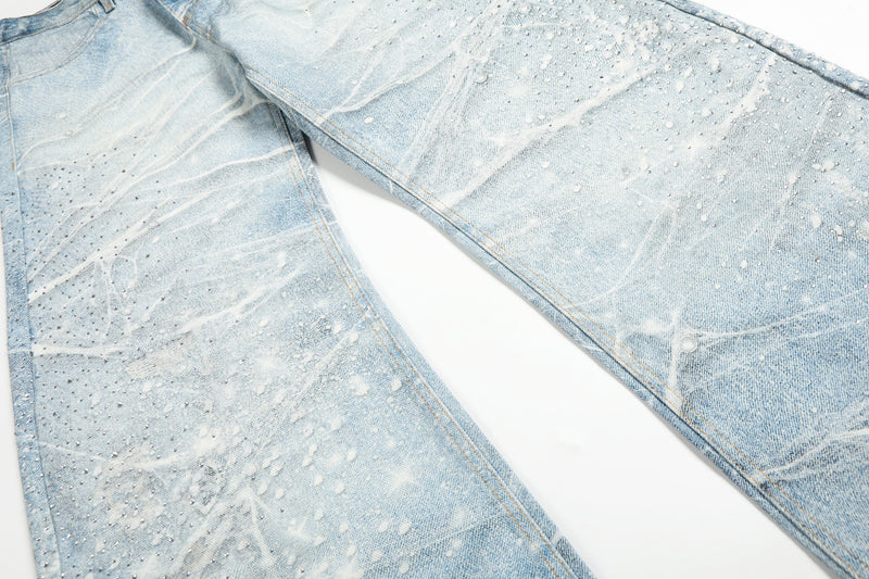 Flat lay of wide-leg jeans showing front and back legs with frosted spiderweb wash