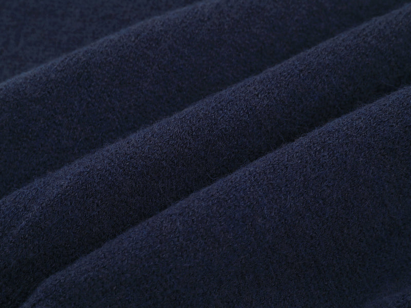 Close-up of dark navy knit fabric texture on the jacket body