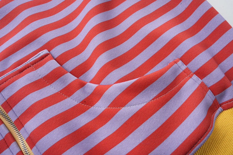 Front upper section of striped zip-up hoodie with yellow hood edge and pocket seam