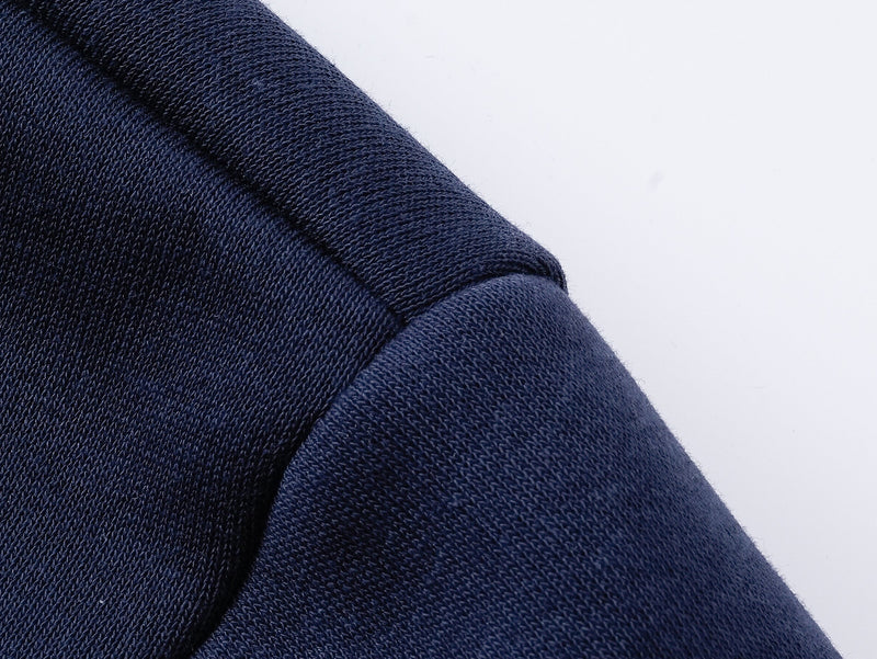 Close-up of navy hoodie shoulder seam and knit fabric texture