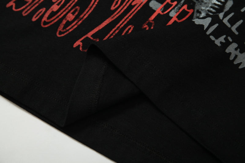 Black graphic patchwork crop tee with red and gray graffiti-style prints on soft cotton fabric