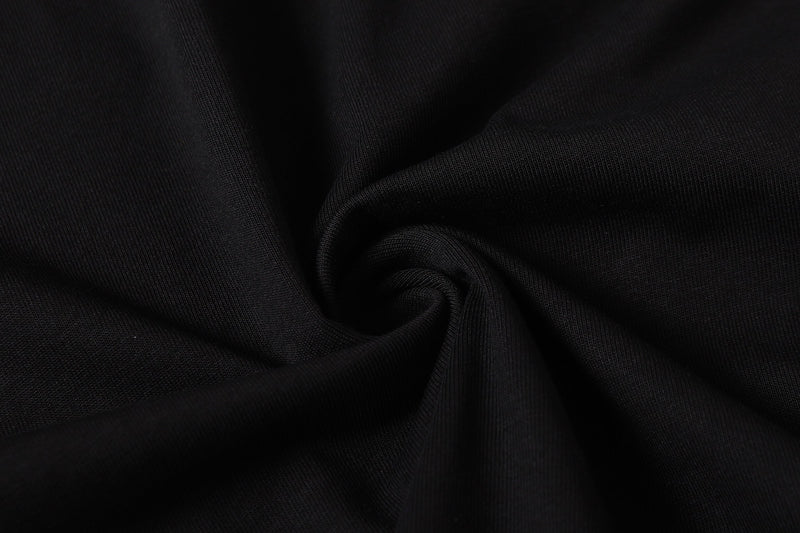 Close-up of black fabric texture with soft folds and ribbed knit detail