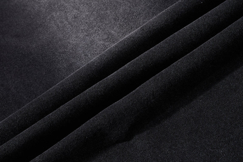 Close-up of black denim fabric folds and woven texture