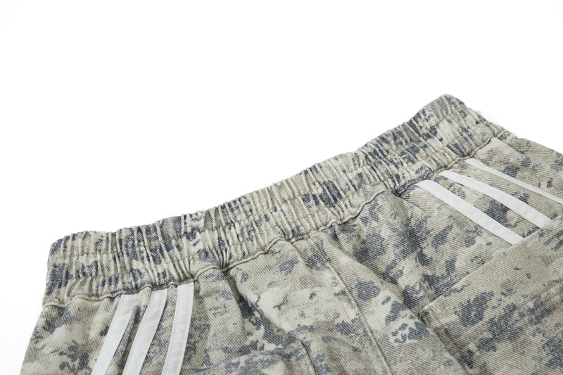 Close-up of elastic waistband and reflective side stripes on camouflage cargo pants
